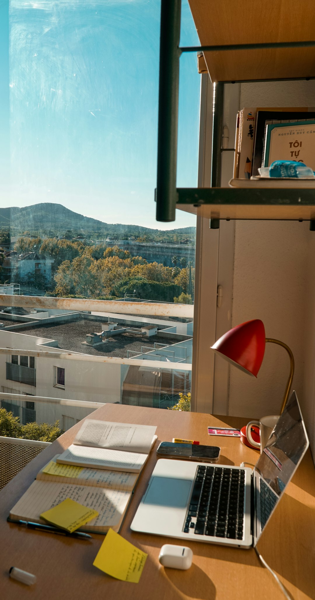 a-desk-with-laptop-looking-over-a-scenic-view-1htnhm41xbq