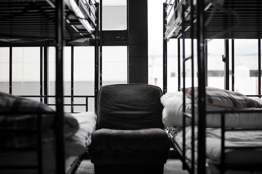 grayscale-photo-of-bunk-bed-and-chair-muko8po-lz8